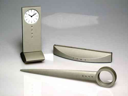 Set aluminum clock, letter opener and magnifier-card holder.